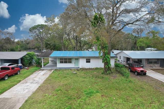 ranch-style home with a front yard and a carport