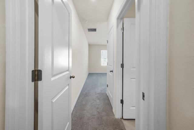 hallway featuring light colored carpet