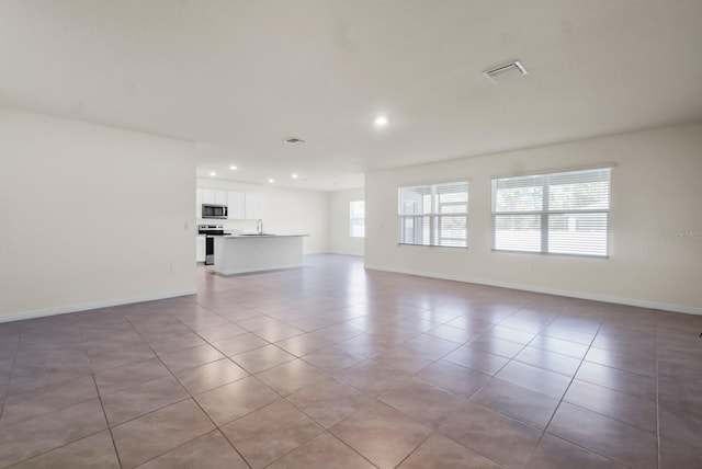 unfurnished living room with light tile patterned floors