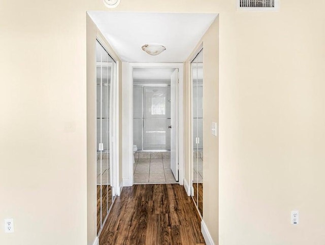 hallway with hardwood / wood-style floors