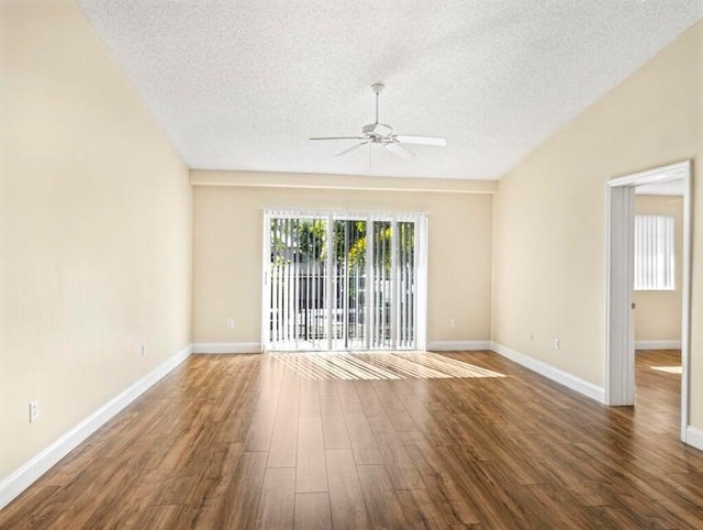 spare room featuring ceiling fan, dark wood-type flooring, and a textured ceiling