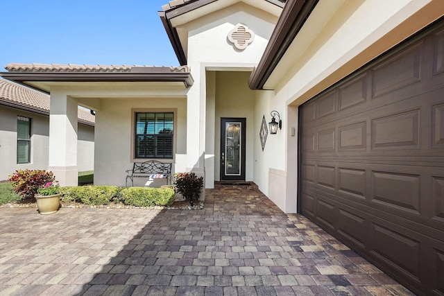 view of exterior entry with a garage