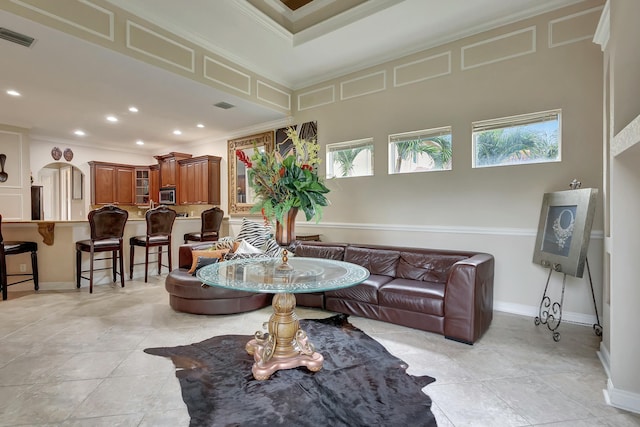 tiled living room with crown molding and plenty of natural light