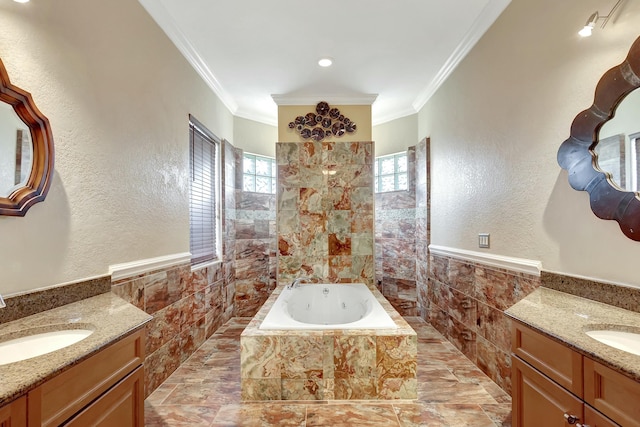 bathroom with vanity, tiled tub, ornamental molding, and tile walls