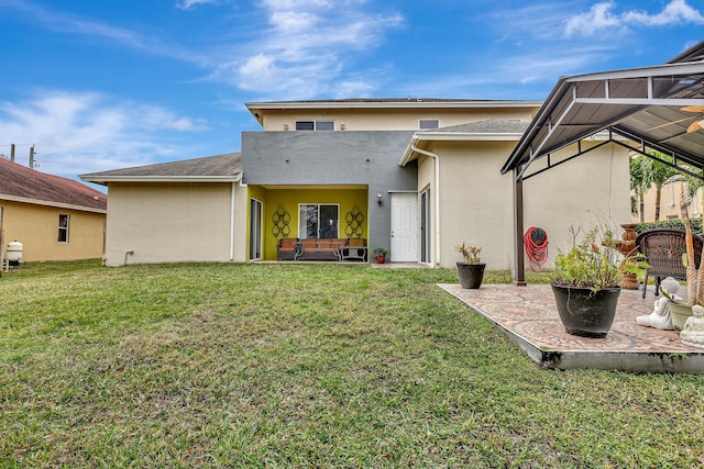 rear view of house with a lawn and a patio area