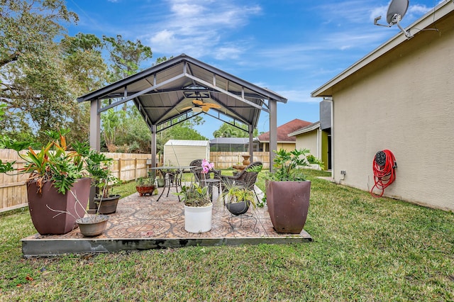 view of patio / terrace featuring a gazebo and ceiling fan