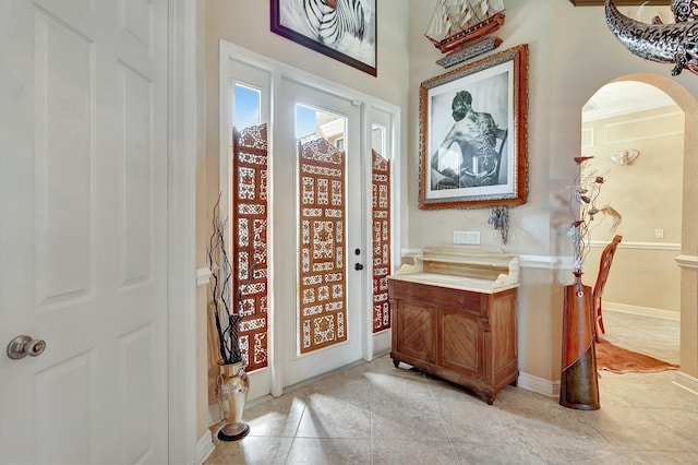 interior space with light tile patterned floors and french doors