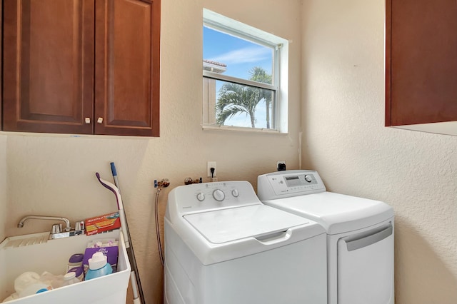 washroom with cabinets and washing machine and dryer