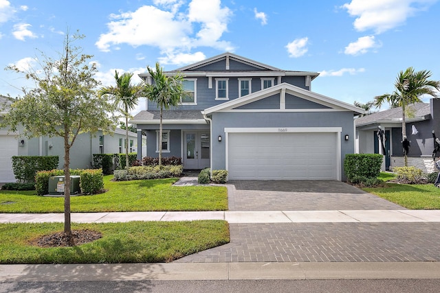 view of front of property with a garage and a front lawn