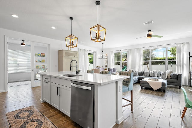 kitchen featuring white cabinetry, sink, a kitchen island with sink, and dishwasher