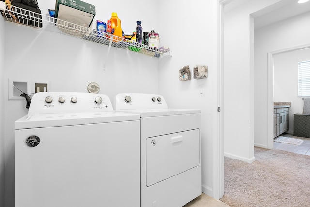 laundry room featuring independent washer and dryer and light colored carpet