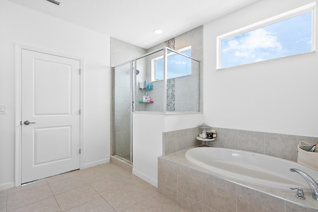 bathroom featuring tile patterned flooring and plus walk in shower