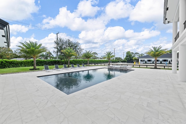 view of swimming pool with a patio area