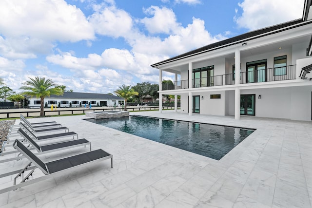 view of pool with an in ground hot tub and a patio area