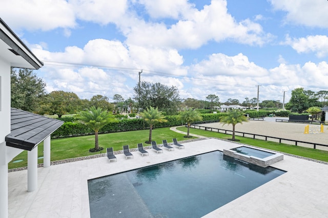 view of swimming pool with a patio, a yard, and an in ground hot tub