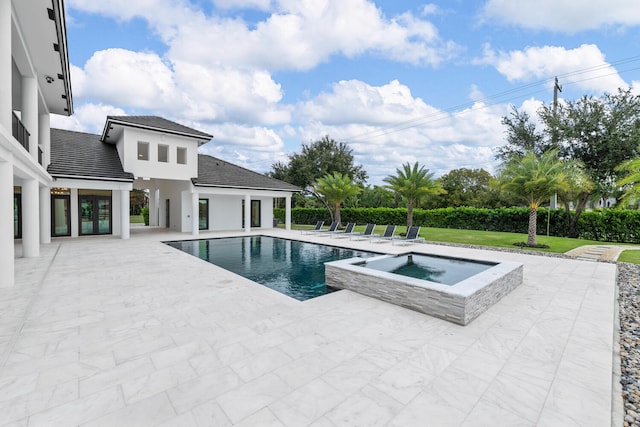 view of swimming pool featuring a yard, a patio area, and an in ground hot tub