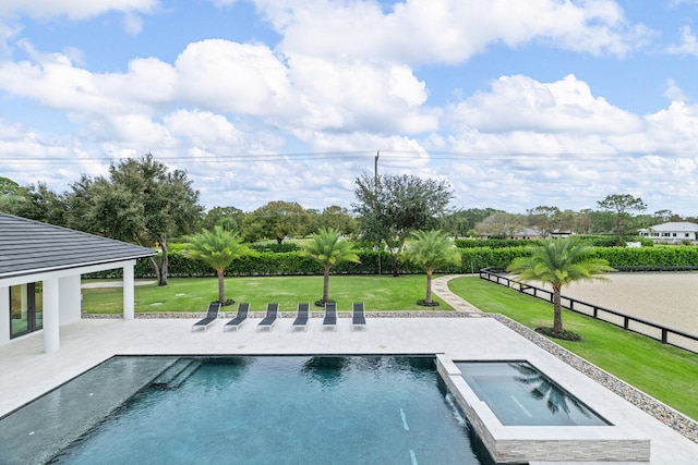 view of swimming pool featuring a patio area, an in ground hot tub, and a lawn