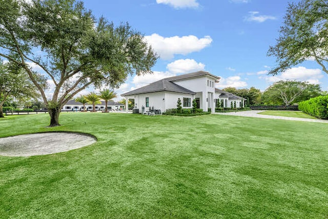 view of property exterior with a lawn