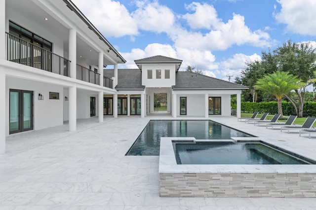 view of swimming pool with an in ground hot tub and a patio area