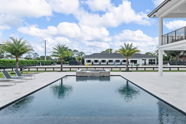 view of pool featuring an in ground hot tub and a patio area