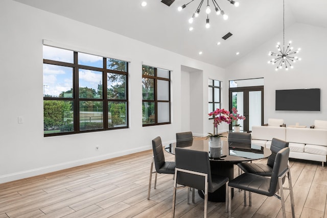 dining space with french doors, a healthy amount of sunlight, and a notable chandelier