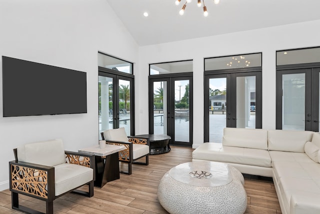 living room featuring high vaulted ceiling and french doors