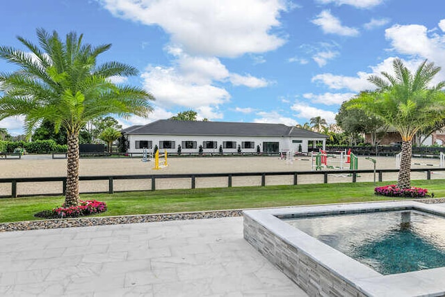 view of pool with a lawn