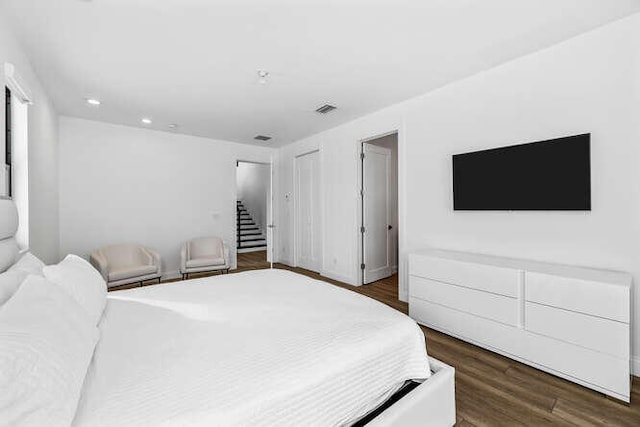 bedroom with dark wood-type flooring