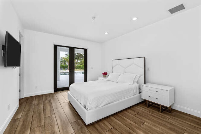 bedroom with french doors, hardwood / wood-style flooring, and access to outside