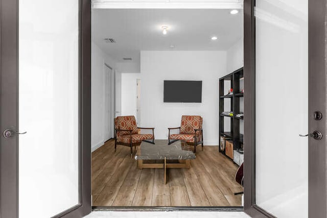 living area with hardwood / wood-style floors