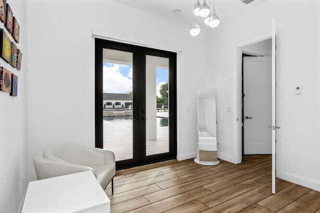 entryway with wood-type flooring and french doors