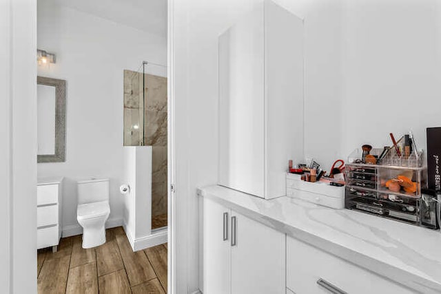 bathroom featuring vanity, toilet, and a shower