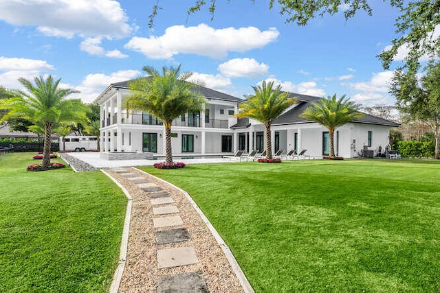 rear view of house featuring a yard and a patio area