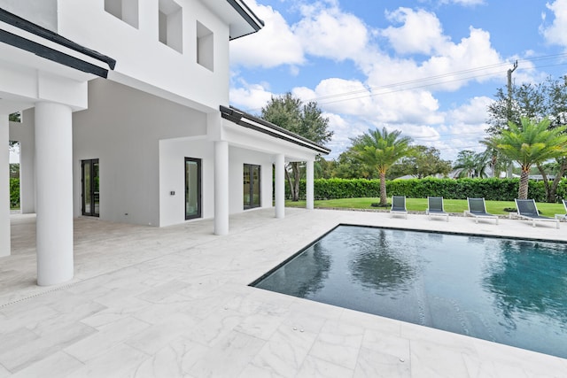 view of pool featuring a patio area and a lawn