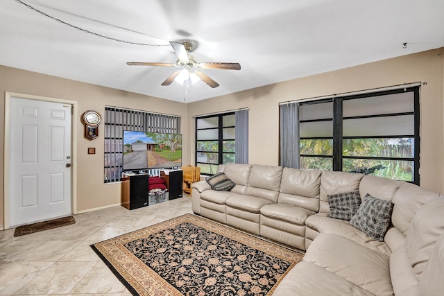 living room featuring light tile patterned flooring, a healthy amount of sunlight, and ceiling fan