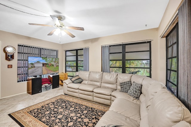 living room with ceiling fan and light tile patterned floors