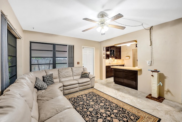 tiled living room featuring sink and ceiling fan