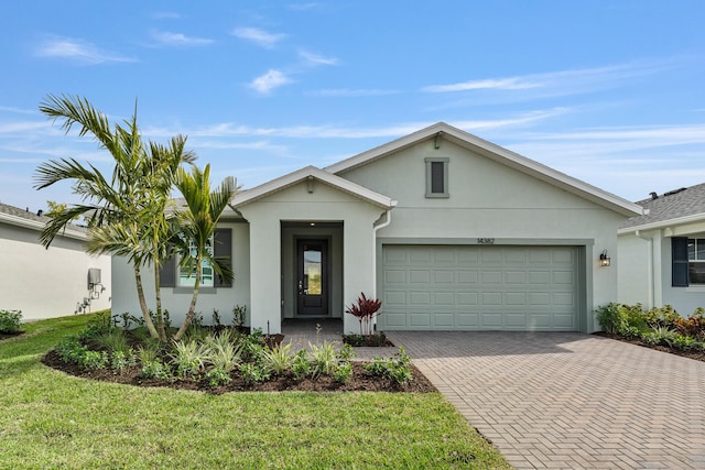 ranch-style home with a garage and a front yard