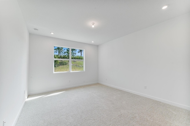 unfurnished room featuring light colored carpet