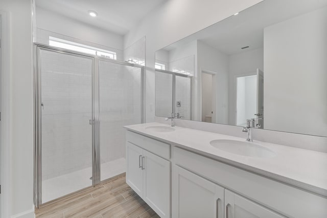 bathroom featuring vanity, wood-type flooring, toilet, and walk in shower