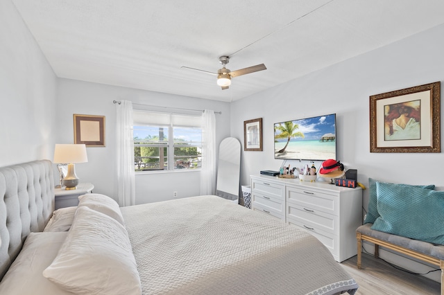 bedroom with ceiling fan and light hardwood / wood-style flooring