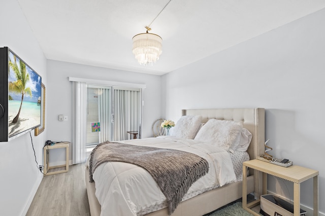 bedroom with wood-type flooring and a chandelier