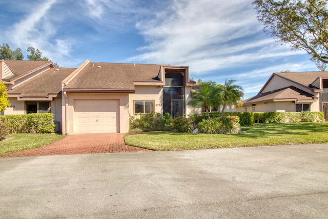 view of front of house featuring a garage and a front yard