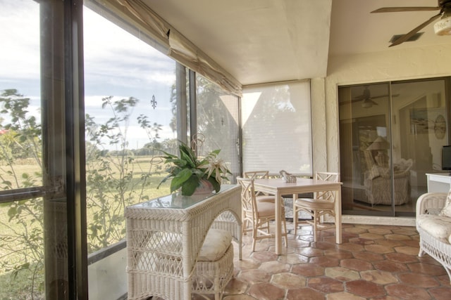 sunroom featuring ceiling fan