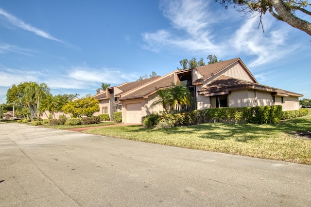 view of front of property with a garage and a front yard