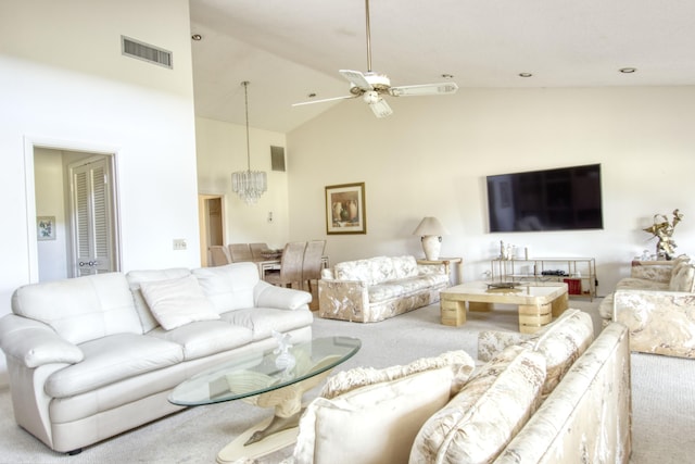 living room with ceiling fan with notable chandelier, high vaulted ceiling, and carpet floors