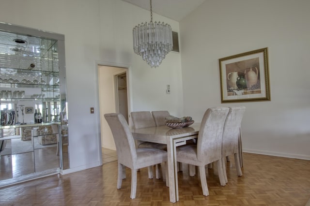 dining room with an inviting chandelier, parquet floors, and high vaulted ceiling