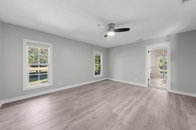 unfurnished room featuring ceiling fan, light hardwood / wood-style flooring, and a textured ceiling