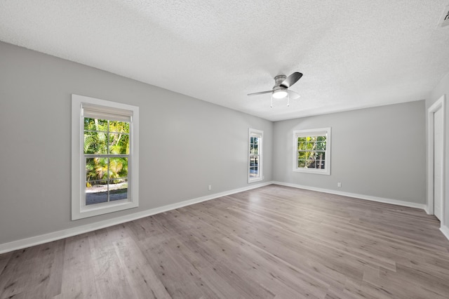 unfurnished room with wood-type flooring, ceiling fan, and a textured ceiling