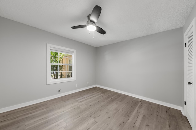 spare room featuring ceiling fan, a textured ceiling, and light hardwood / wood-style floors